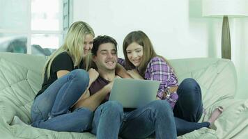 Girls hugging a guy on the couch video