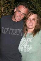 David Eigenberg wearing COTAM shirt with Carly Miller while attending the Daytime for Planned Parenthood Event at a rooftop in Hollywood CA June 18 2008   Hutchins Photo
