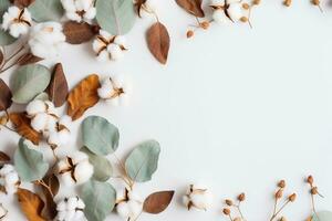 Autumn composition. Frame made of eucalyptus branches, cotton flowers, dried leaves on pastel gray background. Autumn, fall concept. Flat lay, top view, copy space. generative ai. photo