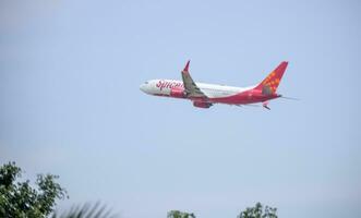 New Delhi, India, April 16 2023 - Spicejet Airbus A320 take off from Indra Gandhi International Airport Delhi, Spicejet domestic aeroplane flying in the blue sky during day time photo