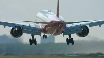 Rear view, plane landing and touching the runway. Haze on the airfield video
