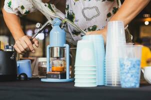 Barista making freshly brewed espresso coffee from a Leverpresso. photo