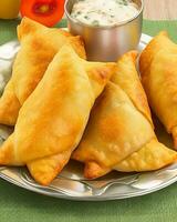 AI Generated Delicious Chicken Samosa with Green Chilli Sos and Dry Chilli Sos free photo