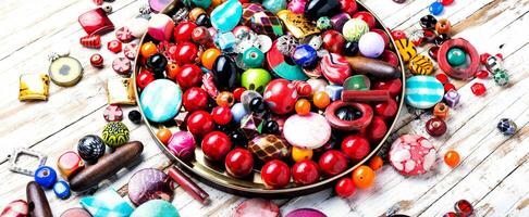Colorful beads on wooden surface photo