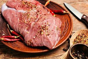 Raw meat with spices photo