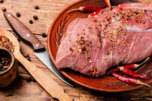 Raw meat with spices photo