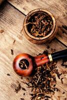 Smoking pipe on a wooden table photo