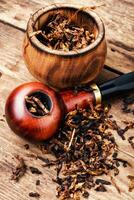 Smoking pipe on a wooden table photo