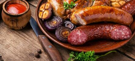 Grilled sausages on wooden board photo