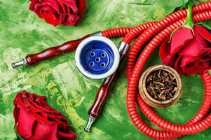 Smoking hookah with rose flavor photo