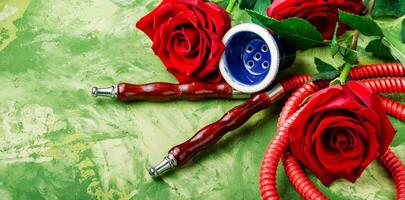 Smoking hookah with rose flavor photo