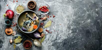 Fish soup in metal pan photo