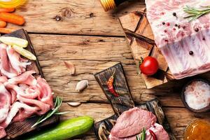 Raw meat on wooden board photo