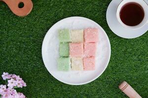 Getuk lindri, traditional food from Java Indonesia against grass background photo