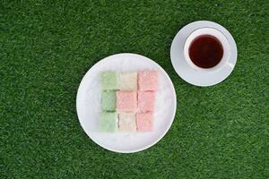 Getuk lindri, traditional food from Java Indonesia against grass background photo