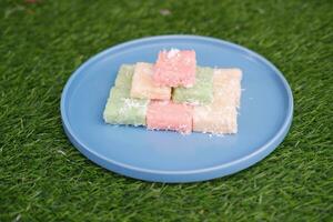 Getuk lindri, traditional food from Java Indonesia against grass background photo