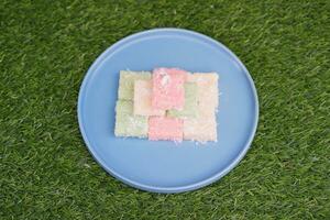 Getuk lindri, traditional food from Java Indonesia against grass background photo