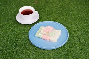 Getuk lindri, traditional food from Java Indonesia against grass background photo