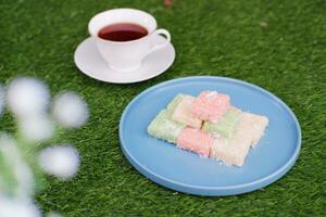 Getuk lindri, traditional food from Java Indonesia against grass background photo
