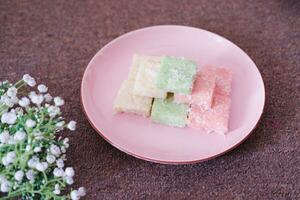 Getuk lindri, traditional food from Java Indonesia against grass background photo