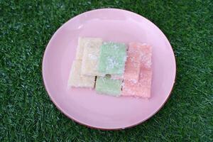 Getuk lindri, traditional food from Java Indonesia against grass background photo