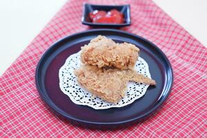 Crispy fried chicken on a plate with sauce, stock photo