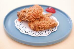 Crispy fried chicken on a plate with sauce, stock photo