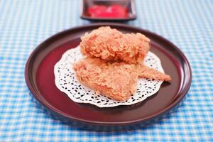 Crispy fried chicken on a plate with sauce, stock photo