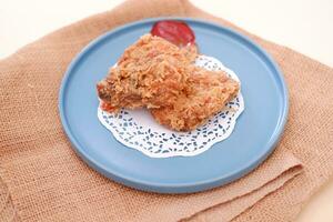 Crispy fried chicken on a plate with sauce, stock photo