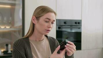 A woman reads the instructions for using medications and washes down the tablet with water. video