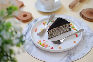 Piece of homemade chocolate crepes cake on a white plate photo