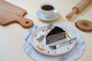 Piece of homemade chocolate crepes cake on a white plate photo
