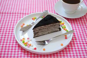 Piece of homemade chocolate crepes cake on a white plate photo