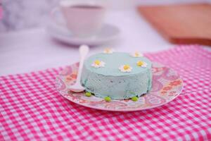 Green tea mousse cake with cup of coffee on the table. photo
