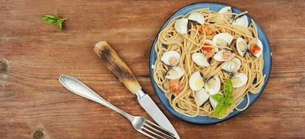 Pasta with fried clams, copy space. photo