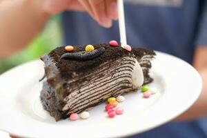 Piece of homemade chocolate crepes cake on a white plate photo