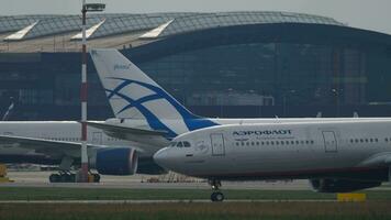 MOSCOW, RUSSIAN FEDERATION JULY 29, 2021 Airbus A330 of Aeroflot on taxiway at Sheremetyevo airport. Passenger airliner Russian Airlines on the airfield. Row of planes in the background video