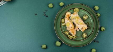 Baked salmon steaks with mini kiwi. photo