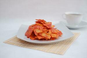 Keripik singkong balado or balado cassava chips on a serving plate, it tastes spicy, sweet and crunchy photo