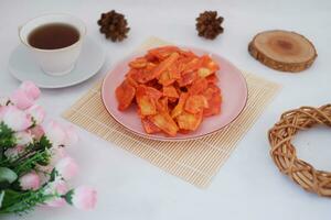 Keripik singkong balado or balado cassava chips on a serving plate, it tastes spicy, sweet and crunchy photo