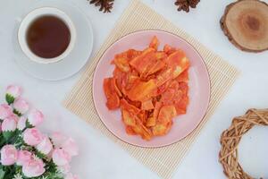 Keripik singkong balado or balado cassava chips on a serving plate, it tastes spicy, sweet and crunchy photo