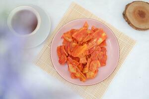 Keripik singkong balado or balado cassava chips on a serving plate, it tastes spicy, sweet and crunchy photo