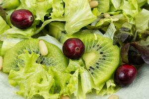 Healthy salad of kiwi and herbs. photo