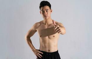 Image of Asian male athlete with good physique on white background photo