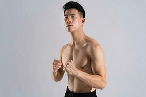 Image of Asian male athlete with good physique on white background photo