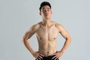 Image of Asian male athlete with good physique on white background photo