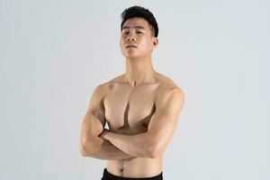 Image of Asian male athlete with good physique on white background photo