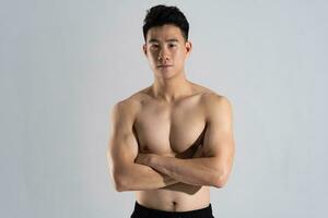 Image of Asian male athlete with good physique on white background photo