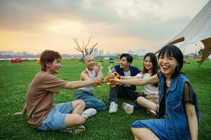 Image of group of friends celebrating and drinking beer together photo