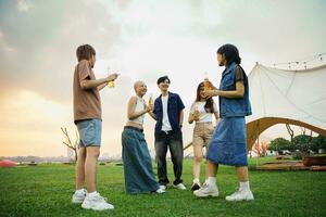 Image of group of friends celebrating and drinking beer together photo